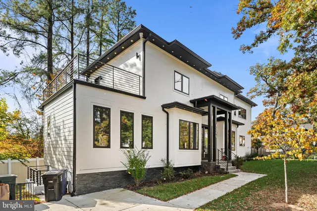 a large kitchen with stainless steel appliances granite countertop a sink a stove and a refrigerator