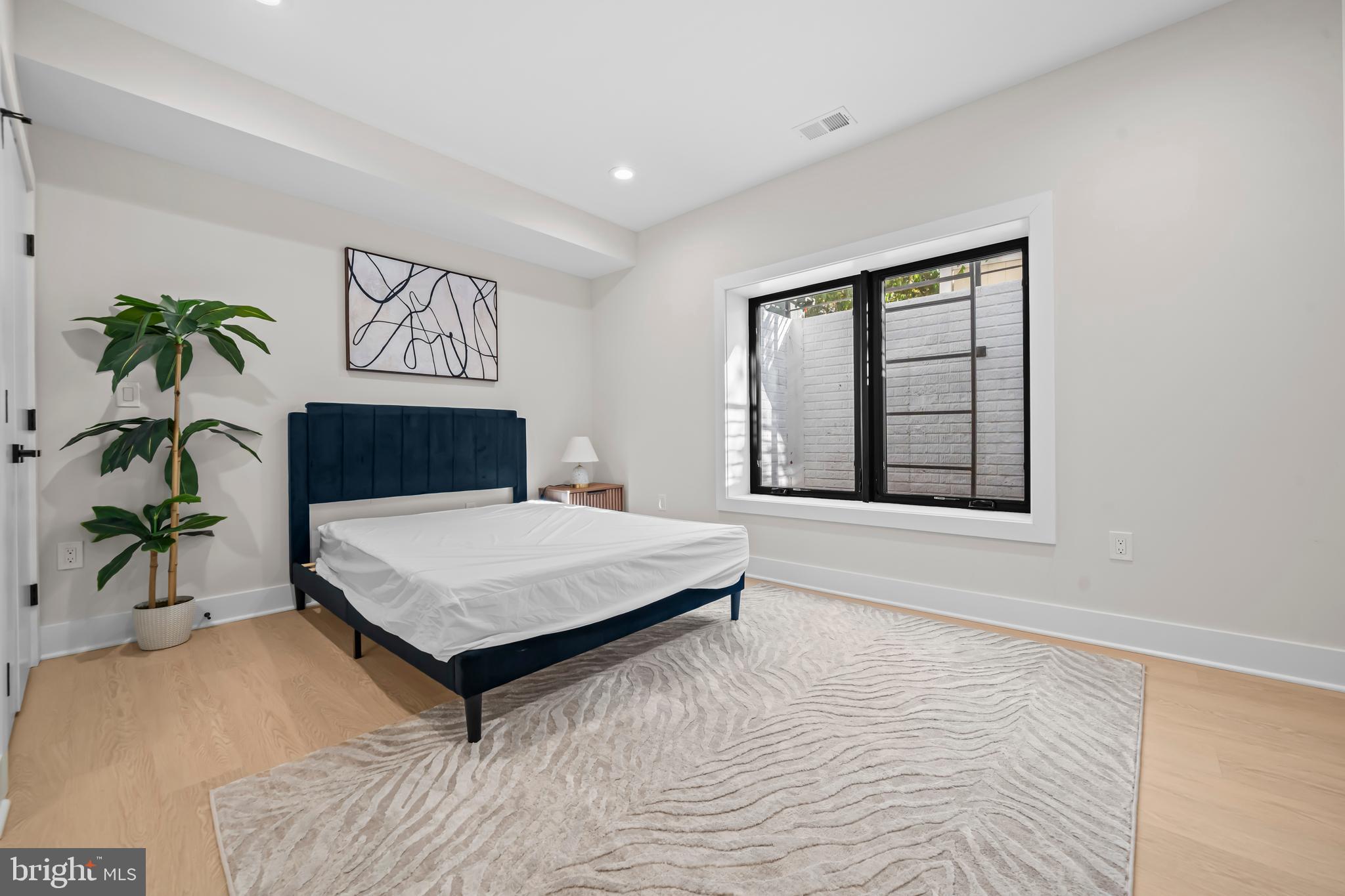 4246 15th Street North Arlington, VA 22207 - Photo 64 of 72 a bedroom with a bed and a potted plant