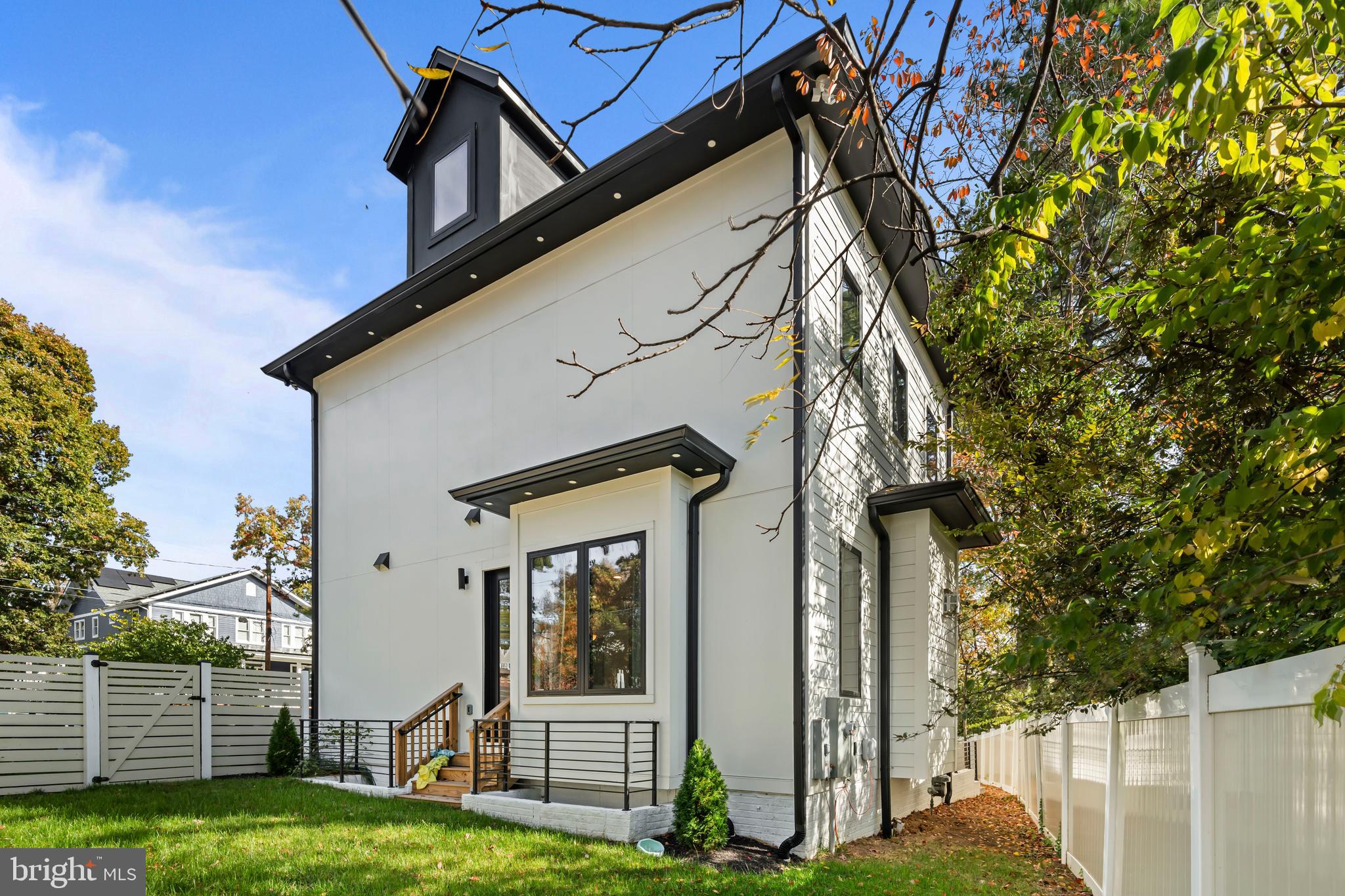 4246 15th Street North Arlington, VA 22207 - Photo 69 of 72 a view of a house with a small yard and wooden fence