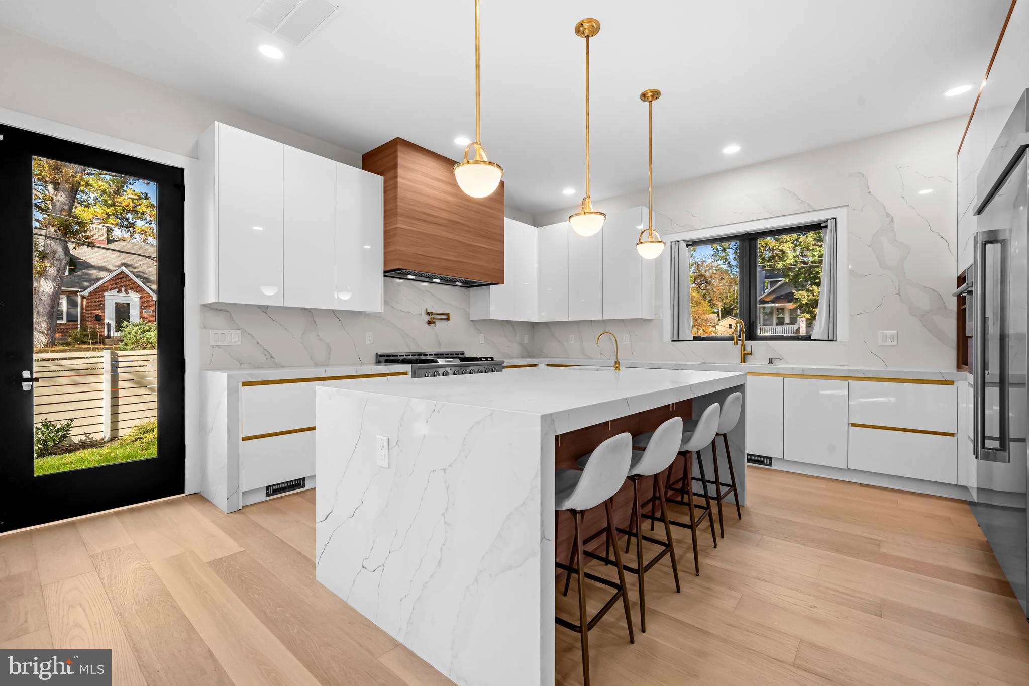 4246 15th Street North Arlington, VA 22207 - Photo 7 of 72 a kitchen with stainless steel appliances granite countertop a stove a sink a oven a dining table and chairs with wooden floor