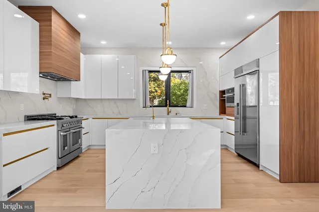 a kitchen with a table chairs a sink dishwasher window and cabinets