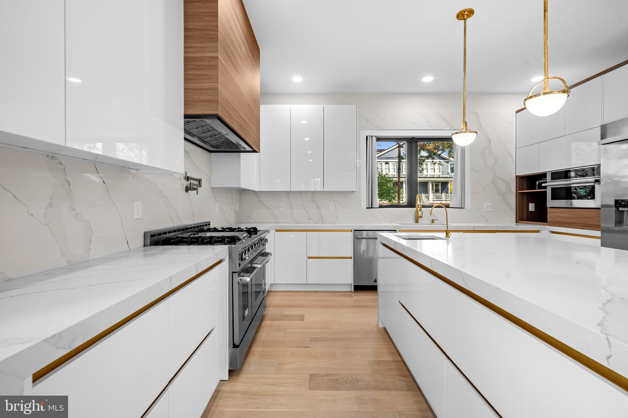 4246 15th Street North Arlington, VA 22207 - Photo 10 of 72 a large kitchen with stainless steel appliances granite countertop a sink a stove and a refrigerator