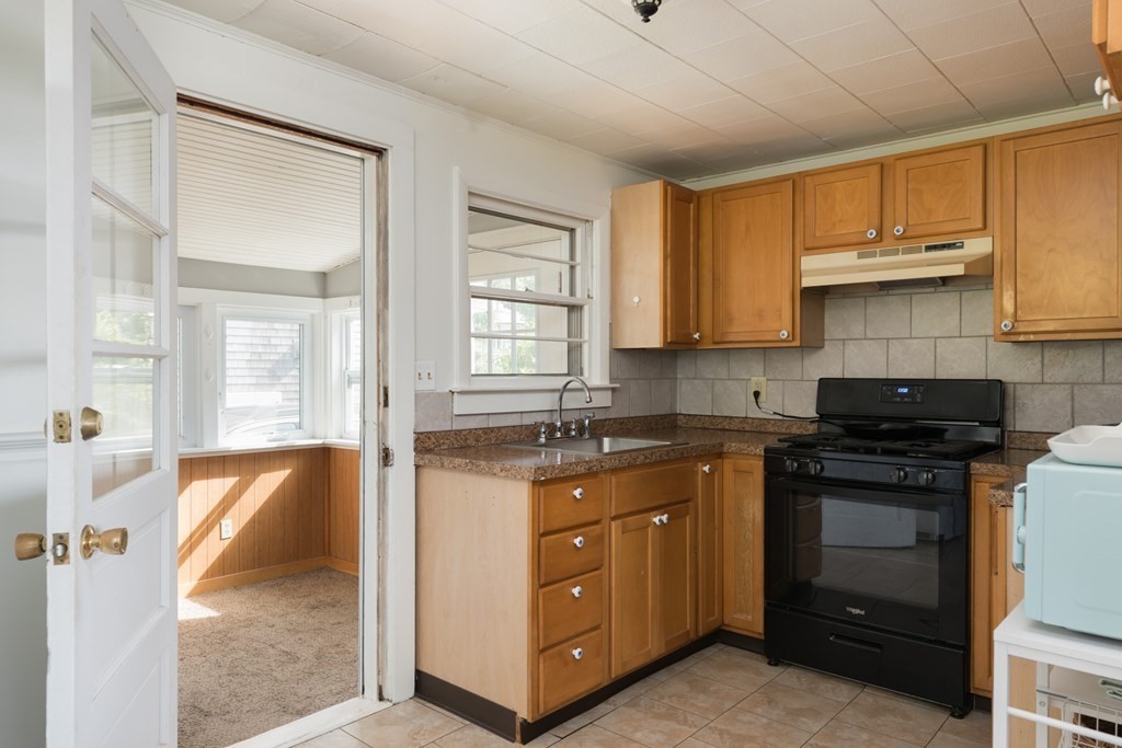 14 Gray Street Wareham, MA 02532 - Photo 15 of 33 a kitchen with stainless steel appliances granite countertop a stove a sink and a microwave