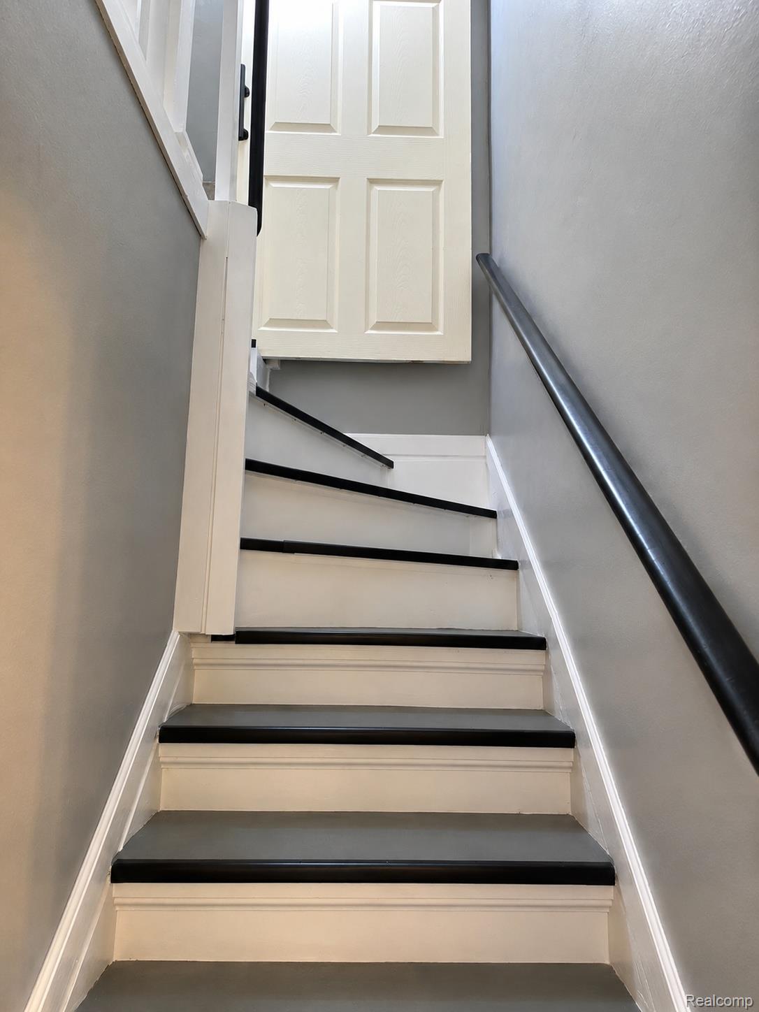 2861 John R Road Rochester, MI 48307 - Photo 19 of 54 Staircase featuring painted treads with dark risers and a dark handrail