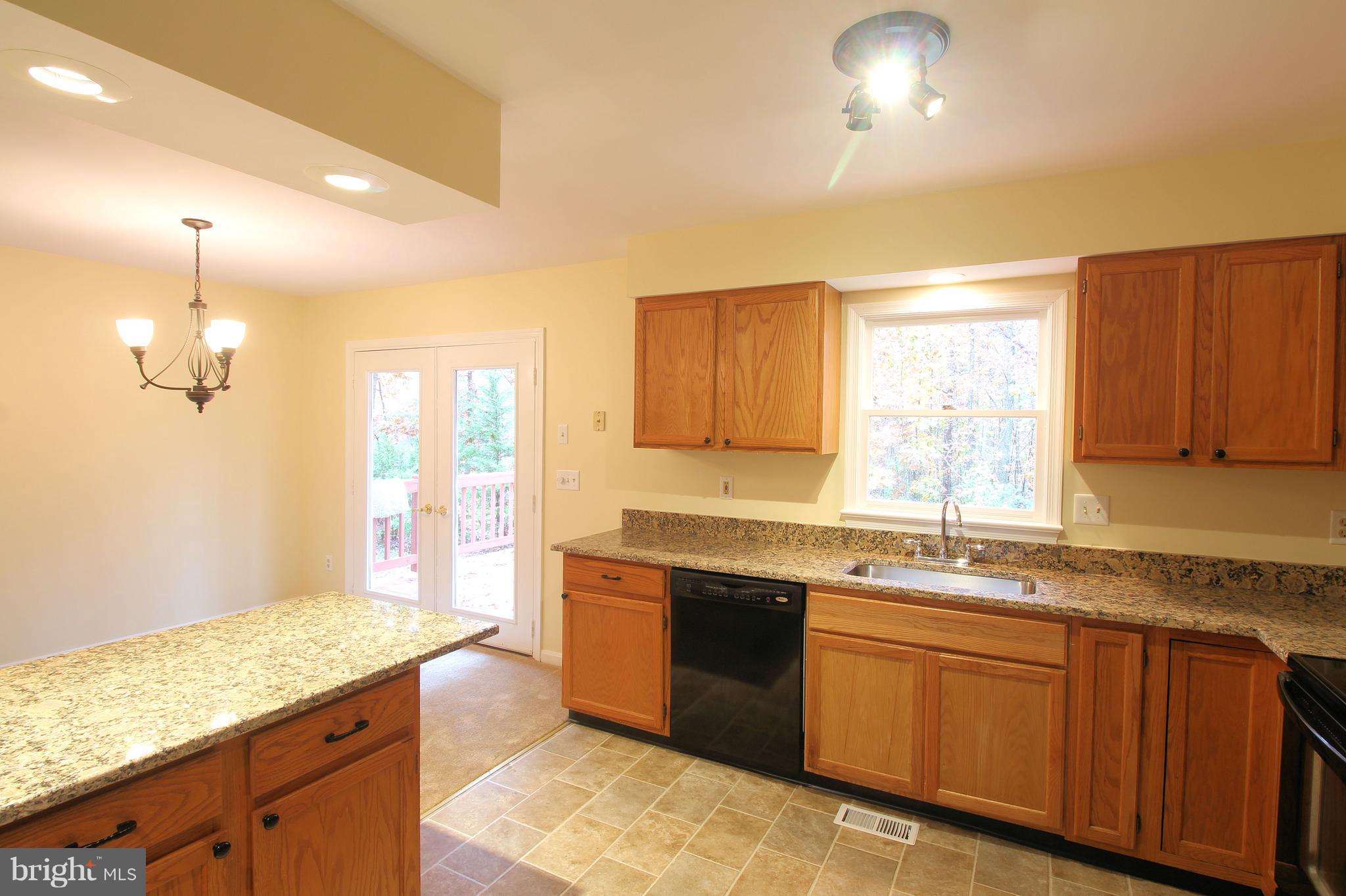113 Saylers Creek Road Locust Grove, VA 22508 - Photo 7 of 29 a kitchen with granite countertop sink stove and cabinets
