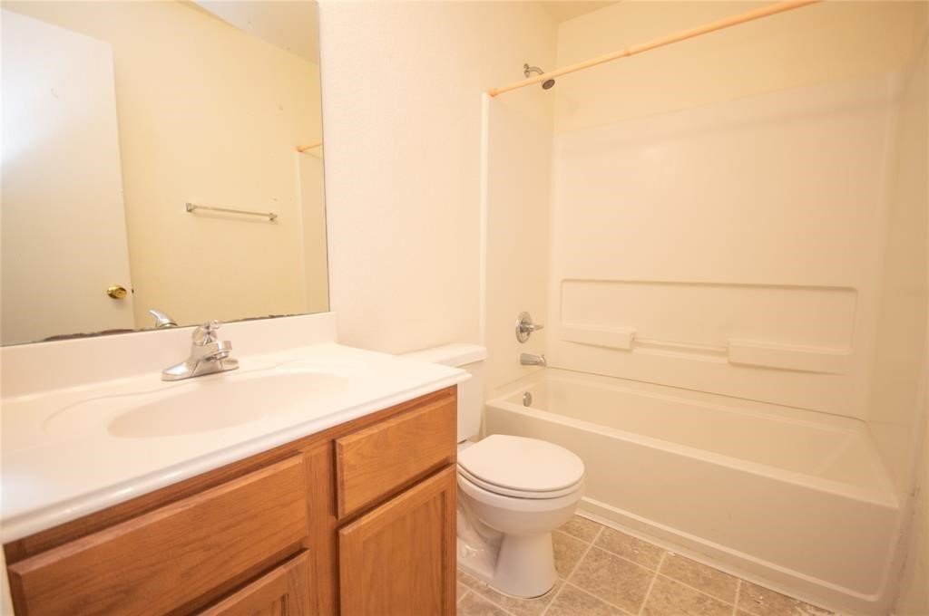 310 Falling Pine Drive Conroe, TX 77304 - Photo 15 of 15 a bathroom with a sink a toilet and shower