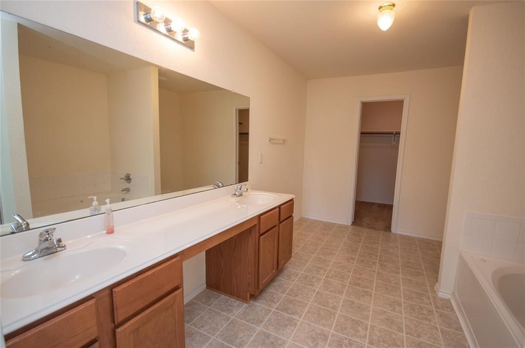 310 Falling Pine Drive Conroe, TX 77304 - Photo 10 of 15 a bathroom with a sink and a mirror