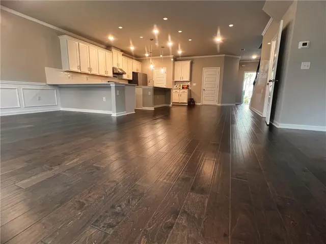 a view of kitchen with cabinets and wooden floor