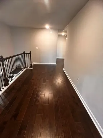 a view of an empty room and wooden floor