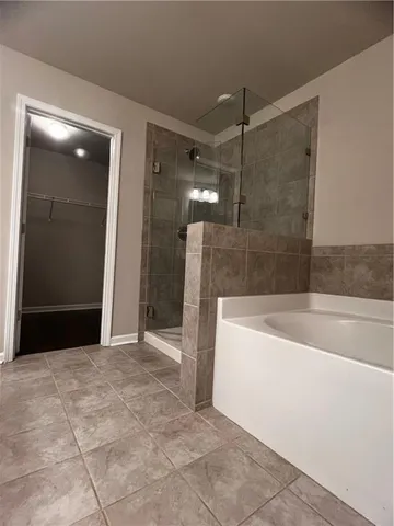 a bathroom with a bathtub and a shower