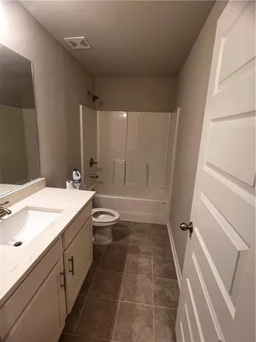 a bathroom with a sink a toilet a mirror and vanity