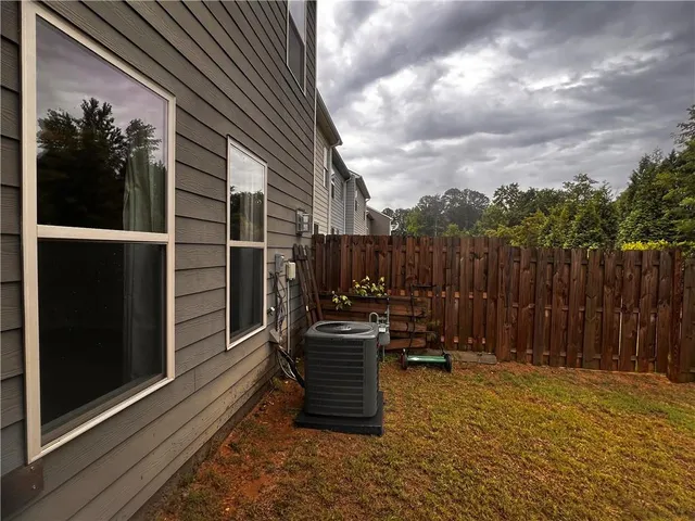 a view of a chairs and table in the back yard of the house