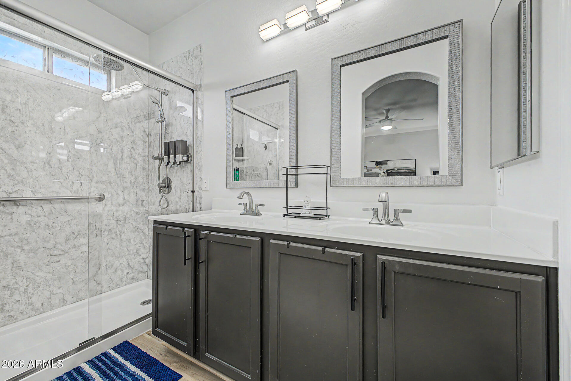 4924 West Harwell Road Laveen, AZ 85339 - Photo 16 of 27 a bathroom with a double vanity sink mirror and shower