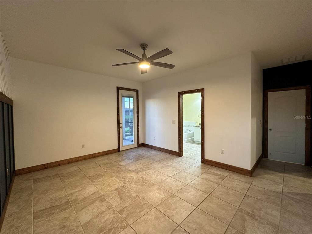 3008 Boat Lift Road Kissimmee, FL 34746 - Photo 18 of 56 an empty room with a ceiling fan and carpet