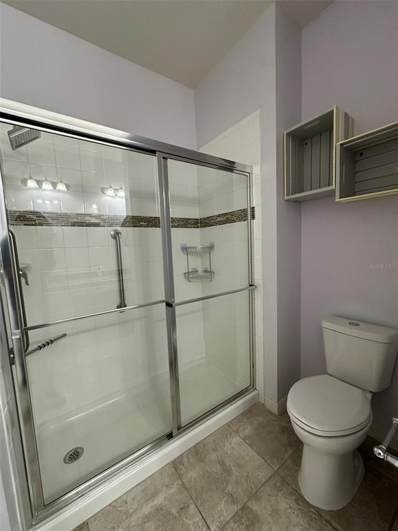 3008 Boat Lift Road Kissimmee, FL 34746 - Photo 27 of 56 a bathroom with a toilet a sink and shower