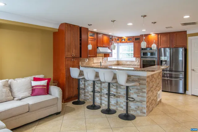a bathroom with a granite countertop sink and a large mirror