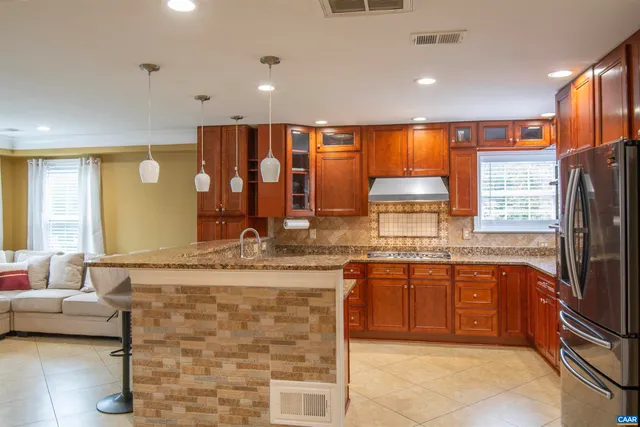 a kitchen with granite countertop a sink stove and cabinets