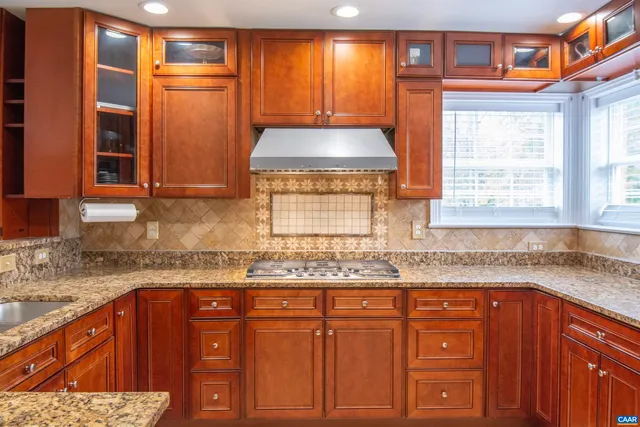 a kitchen with granite countertop stainless steel appliances and cabinets