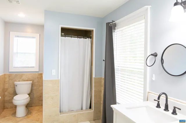 a kitchen with granite countertop sink and cabinets