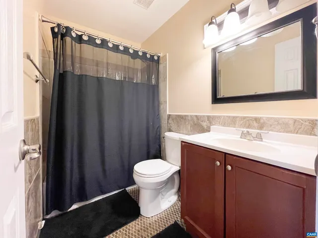 a bathroom with a sink toilet a mirror and shower