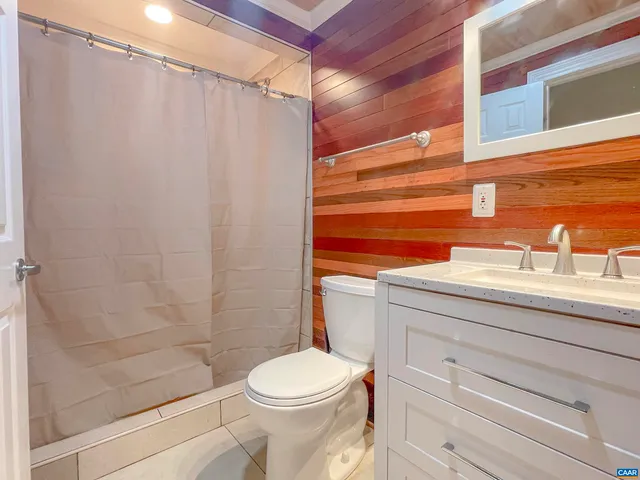 a bedroom with bed and a chandelier