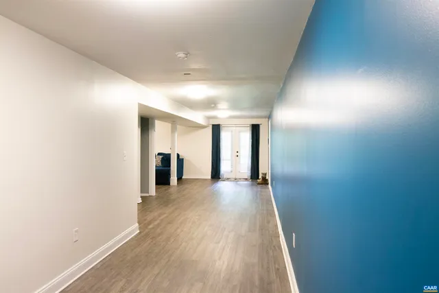 a room with a dresser and a chandelier