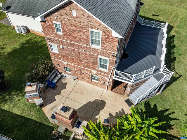 an aerial view of residential house with outdoor space and trees around