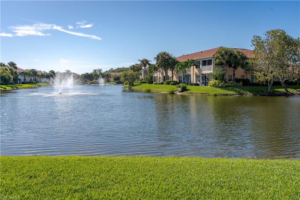 a view of a lake with houses in the back