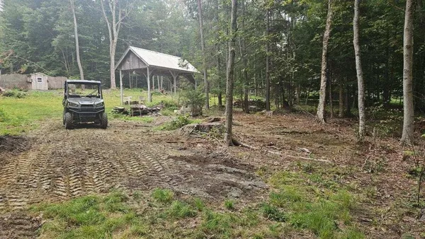 a backyard of a house with table and chairs