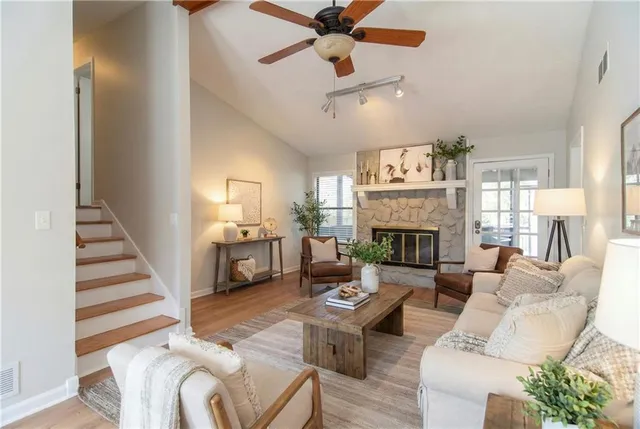 a living room with furniture fireplace and a chandelier