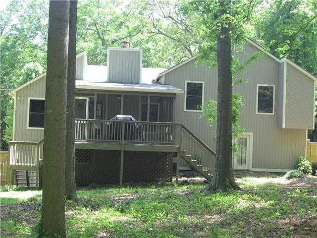 a view of house with backyard