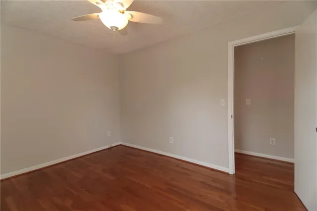 a view of a small space with wooden floor and a window