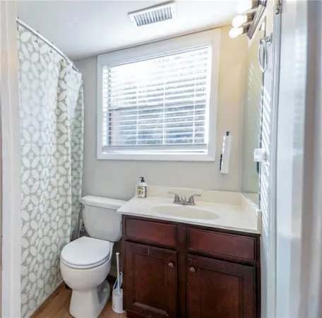 a bathroom with a sink toilet and mirror