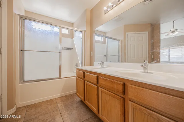 a bathroom with a double vanity sink and mirror