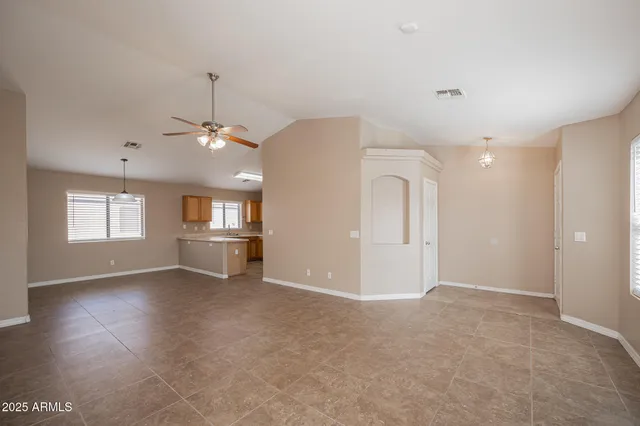 an empty room with windows and entrance