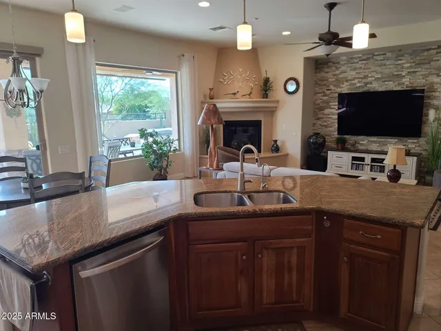 a kitchen with granite countertop a sink and a stove with wooden floor