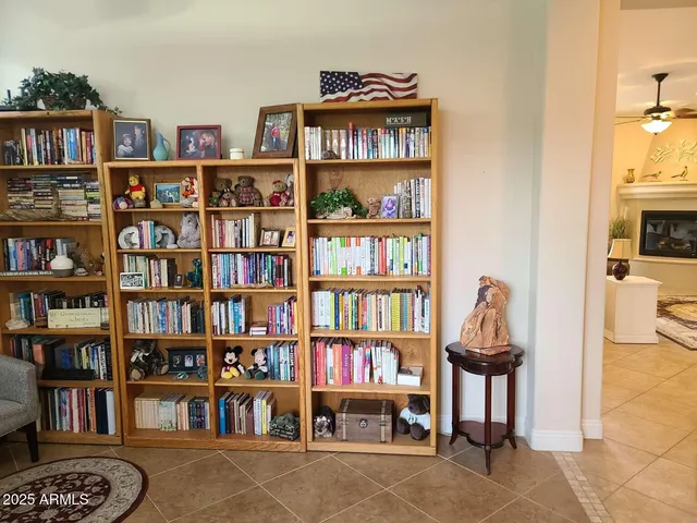 a bedroom with a bed wooden floor and window
