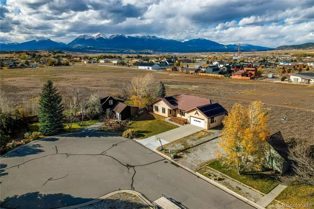 an aerial view of residential houses with outdoor space