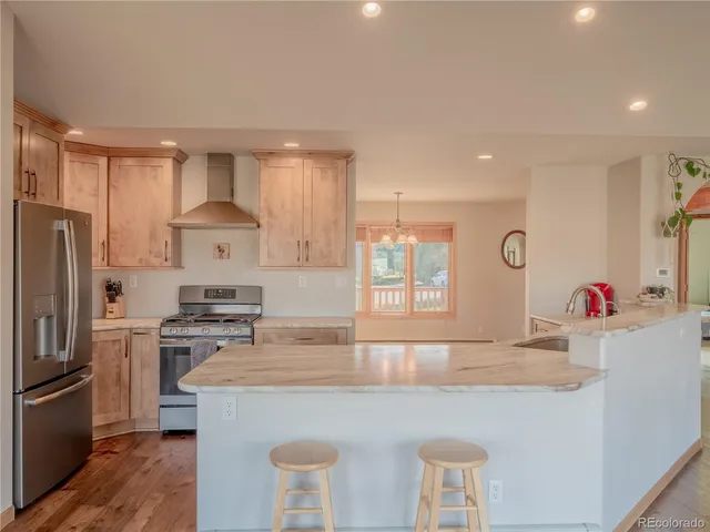 a kitchen with granite countertop a stove and refrigerator