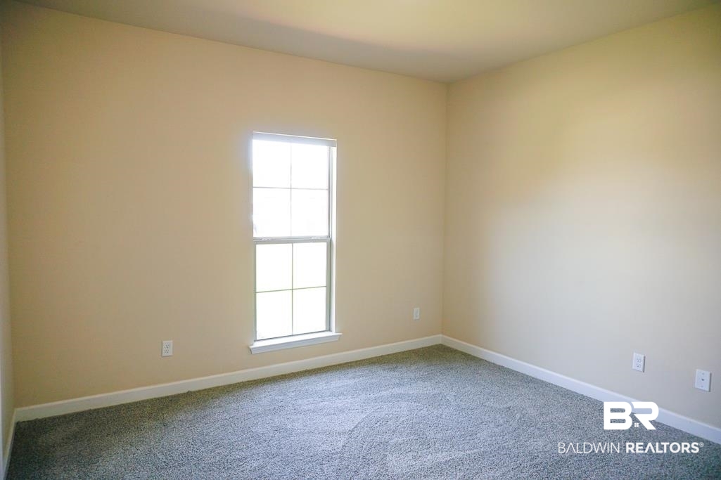 593 Begeman Road Mobile, AL 36608 - Photo 17 of 23 Empty room featuring a wealth of natural light and carpet floors