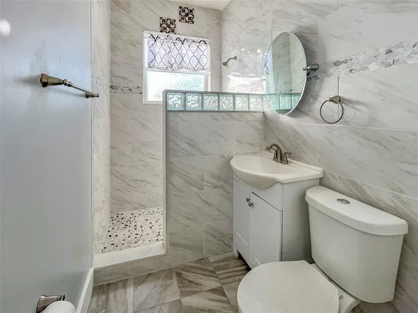 a bathroom with a toilet sink and shower