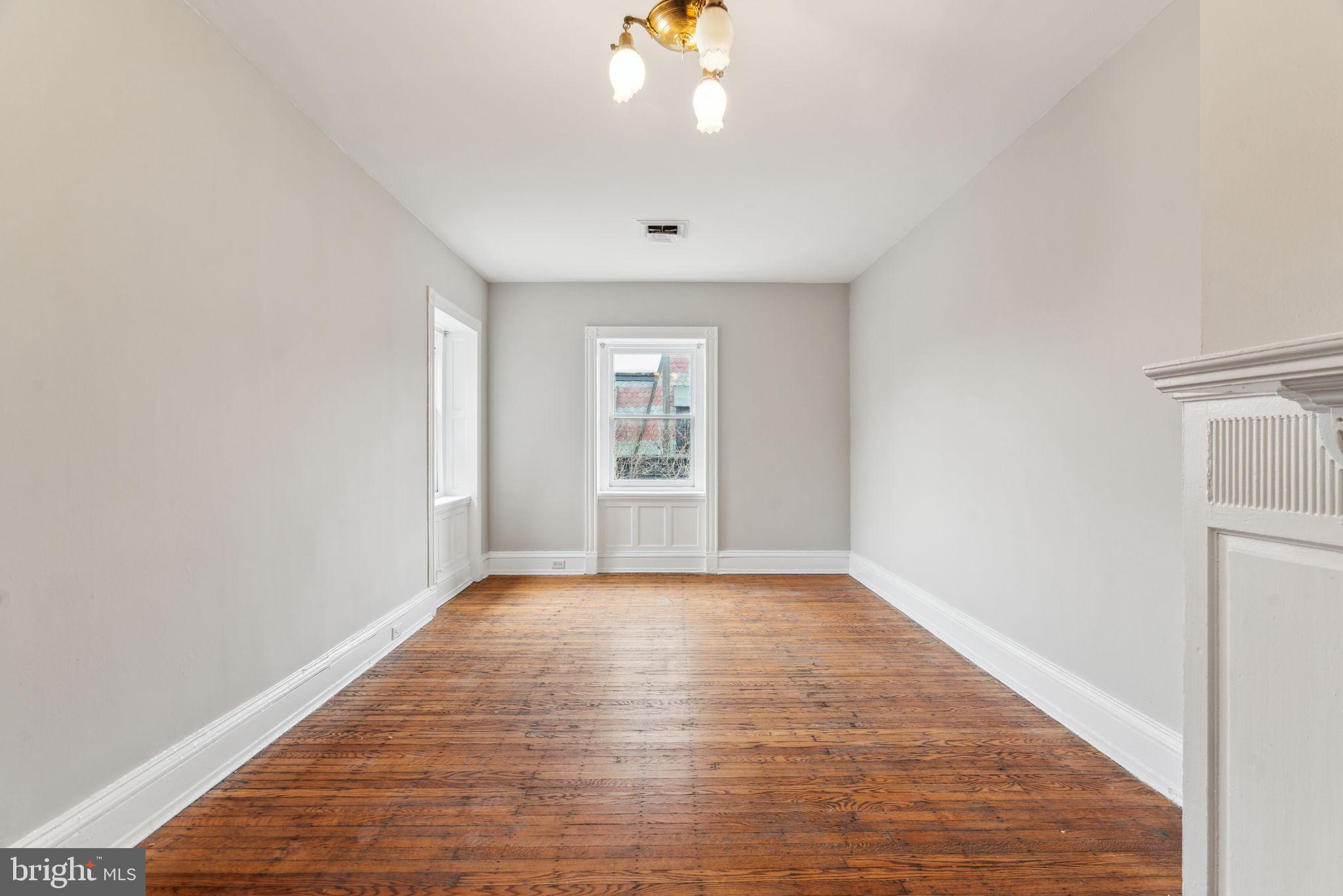 2101 Spruce Street, Unit 4F Philadelphia, PA 19103 - Photo 15 of 24 a view of an empty room with window and wooden floor