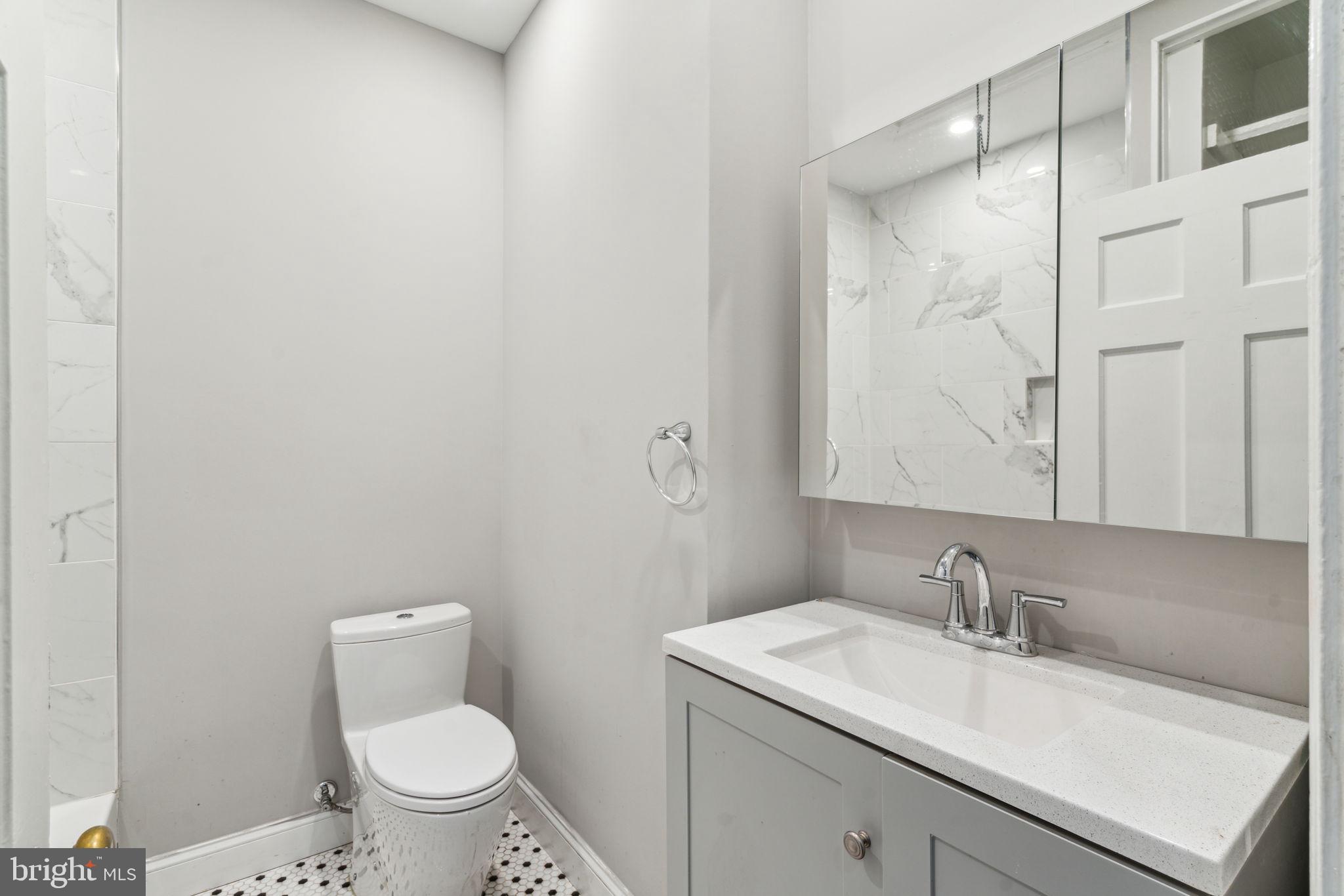 2101 Spruce Street, Unit 4F Philadelphia, PA 19103 - Photo 16 of 24 a bathroom with a sink toilet and vanity