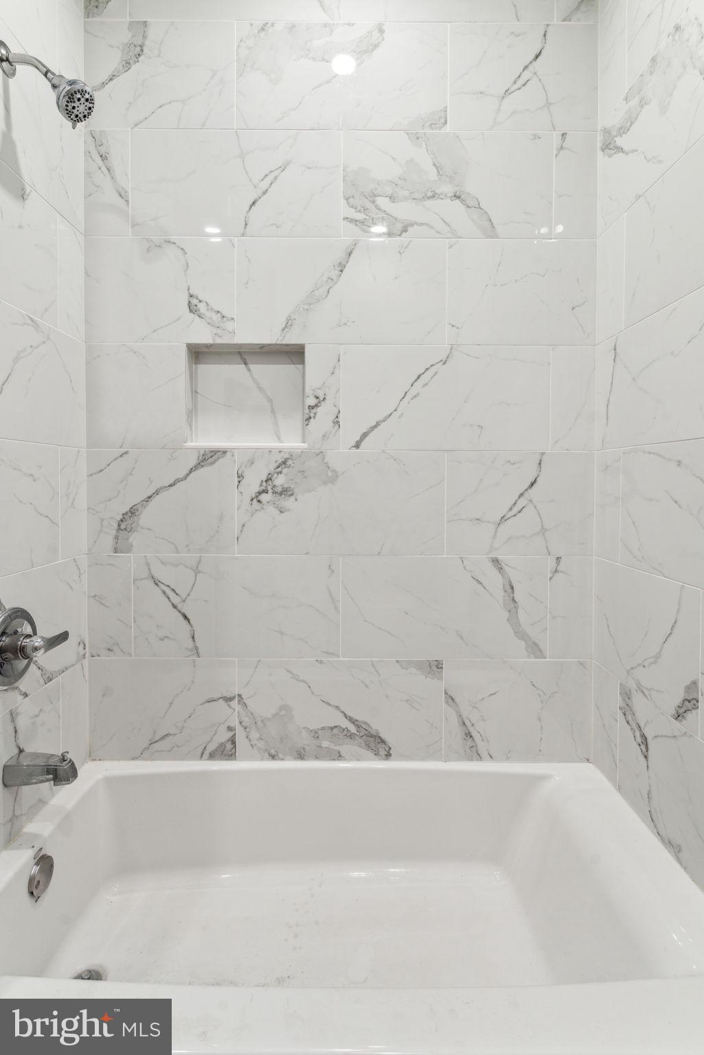 2101 Spruce Street, Unit 4F Philadelphia, PA 19103 - Photo 18 of 24 a bathroom with a bathtub and a shower