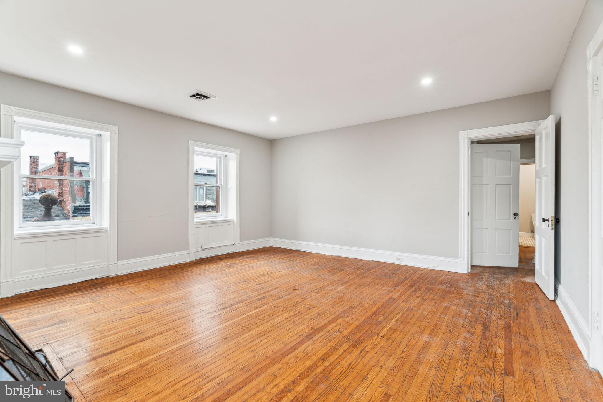 2101 Spruce Street, Unit 4F Philadelphia, PA 19103 - Photo 9 of 24 a view of an empty room with wooden floor and a window