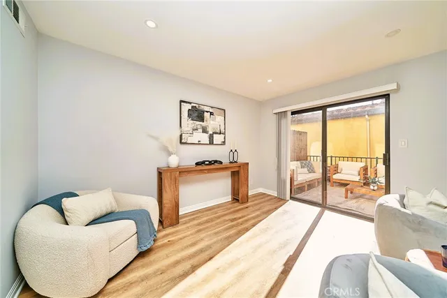 a bedroom with furniture and a large window