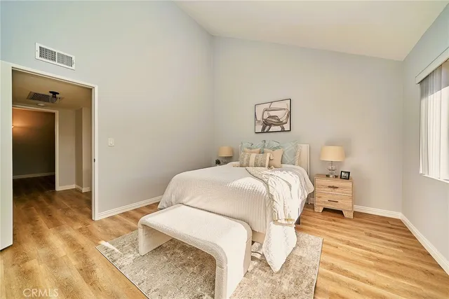 a bedroom with a bed and a window