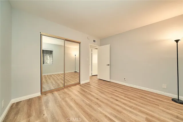 a view of an empty room and wooden floor