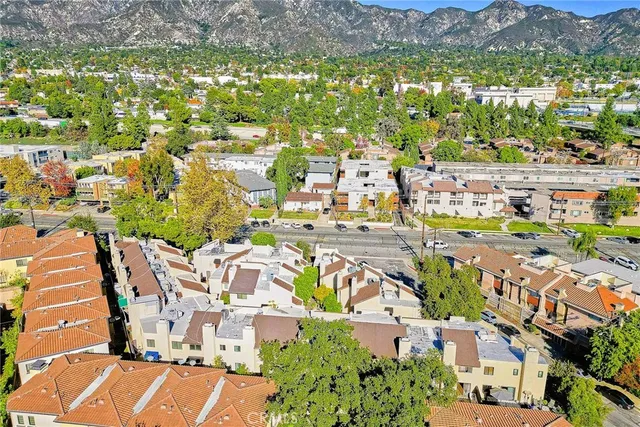 a view of residential houses with outdoor space and street view