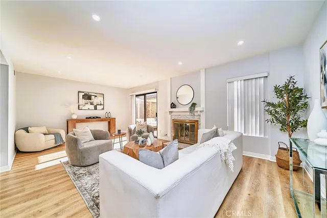a living room with fireplace furniture and a wooden floor